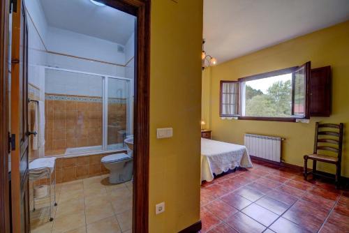 a bedroom with a bed and a bathroom with a shower at Posada de Ajo in Ajo