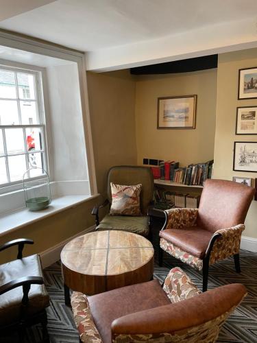 a living room with chairs and a table and a window at Royal Oak Hotel in Rosthwaite