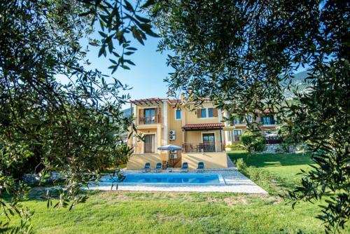 a large house with a swimming pool in a yard at VILLA IRIDA in Kefallonia