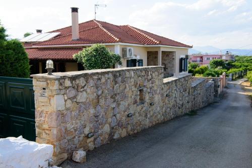 a stone wall in front of a house at Kiveri Garden Villa in Kiveri