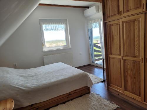 A bed or beds in a room at Borostyán Ház