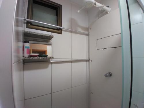 a bathroom with a shower with a glass door at Residence 207 Cabo Branco in João Pessoa