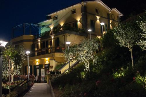 a building with lights on the side of it at night at Hotel Ca' di Gali in Sasso Marconi
