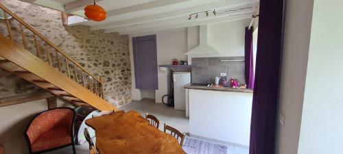 a small kitchen and stairs in a small room at Bienvenue aux Lavandières. in Montrollet