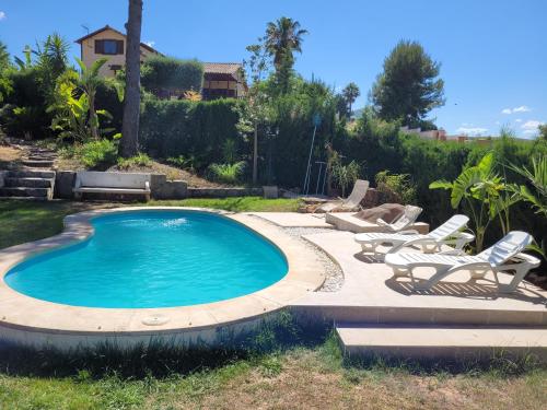 una piscina con tumbonas alrededor en Casa Vacacional Altury Valencia, en Turís
