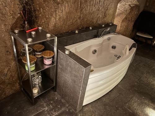 a large bath tub in a bathroom with a shelf at Il Nido Etrusco in Orvieto
