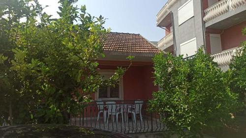 a table and chairs on a balcony of a house at Lemon Tree in Ulcinj