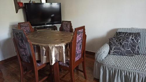 a room with a table and a tv and a bed at Lemon Tree in Ulcinj