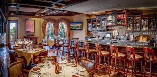 a restaurant with tables and chairs and a bar at Rosen Shingle Creek Universal Blvd in Orlando