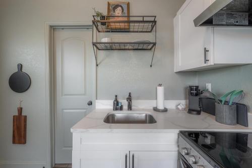 a kitchen with a sink and a white counter top at Updated Condo in Heart of Tampa in Tampa
