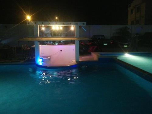 a swimming pool at night with a gazebo at Terramar Hoteles in Crucita