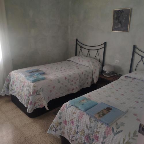 a bedroom with two beds and a table at Cala Llanetes in Vinaròs