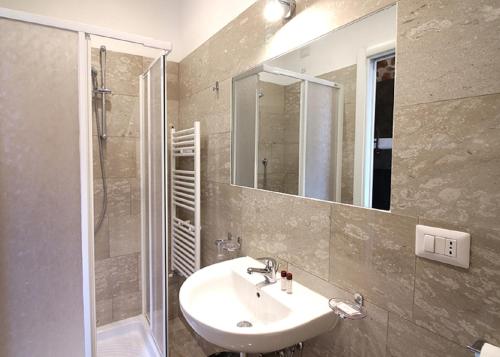 a bathroom with a sink and a shower and a mirror at Foresteria Sociale San Marco Venice in Venice