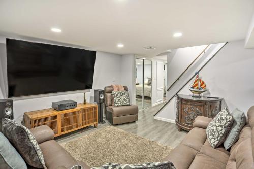 a living room with a large flat screen tv at Saddle Brook Studio with Patio - Near NYC! in Saddle Brook