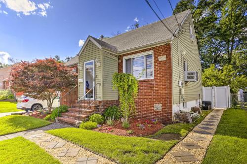 a green house with a brick house at Saddle Brook Studio with Patio - Near NYC! in Saddle Brook
