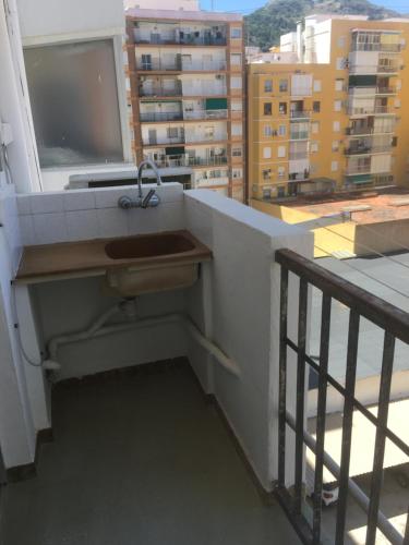 a sink on a balcony with a view of a city at MAGNO CULLERA- Playa in Cullera