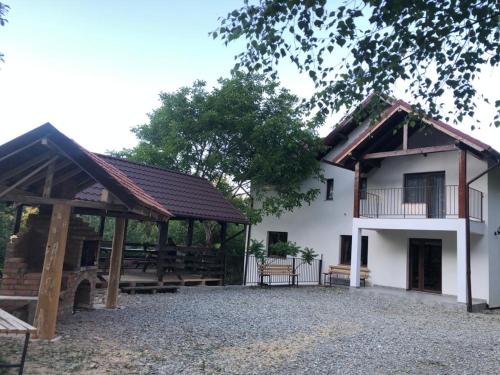 a building with a pavilion next to a building at Conacul din Pădure in Poiana Mărului