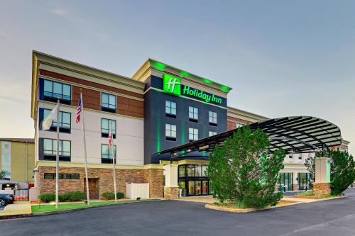 a hotel with a sign on the front of it at Holiday Inn Mobile Airport by IHG in Mobile