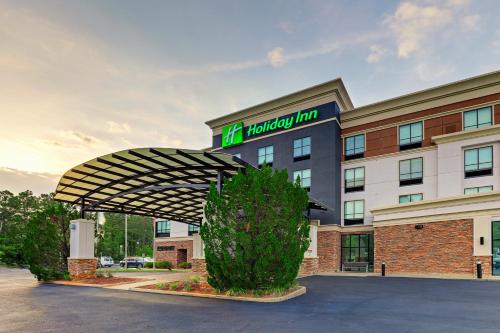 a hotel with a sign on top of a building at Holiday Inn Mobile Airport by IHG in Mobile