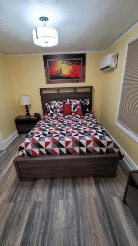 a bedroom with a large bed with a checkered blanket at Lovely rental unit with free parking on premises in Clearwater