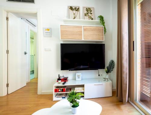 a living room with a flat screen tv on a wall at Apartamento Buen Camino in Benidorm