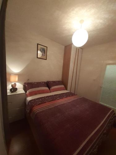 een kleine slaapkamer met een bed en een lamp bij APP Kolar in Umag