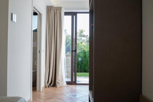 a room with a door open to a glass door with a window at Paradise Sicily Rooms in Calatabiano