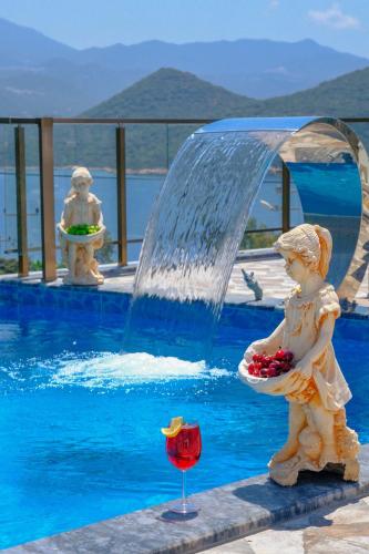 a statue of a little girl sitting next to a fountain at Kaş Sun Glare Hotel in Kas