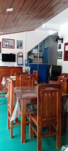 a dining room with a wooden table and chairs at The Green Village Dambulla in Dambulla