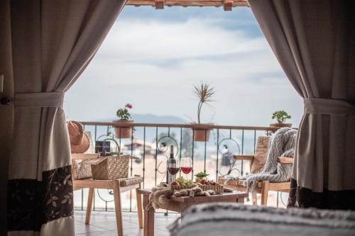 a room with a balcony with a view of the ocean at Hotel el Leñador in Mazamitla
