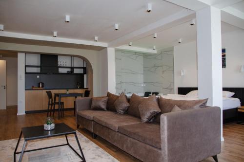 a living room with a couch and a bedroom at Swiss Apartments Prishtina in Prishtinë