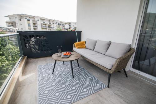 a balcony with a couch and a coffee table at July in Trebinje