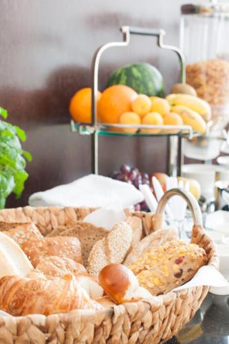 a basket of bread and other foods on a table at Hotel Am Burgmannshof in Wunstorf
