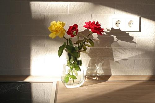 a vase filled with flowers sitting on a table at My Home in RHO in Koskinou