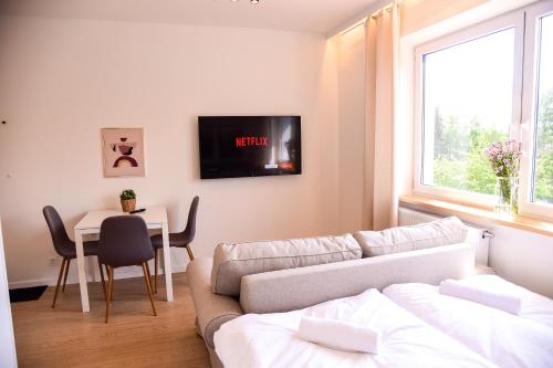 a living room with a couch and a table at Apartamenty Turystyczna 25 in Kudowa-Zdrój