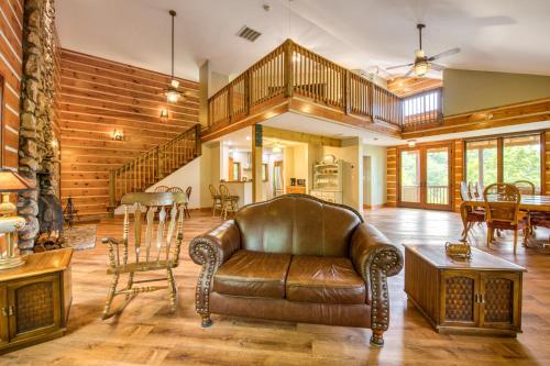a living room with a leather couch and a table at Close to Heaven in Sylva