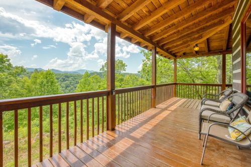 a porch with two chairs and a view of the mountains at Close to Heaven in Sylva