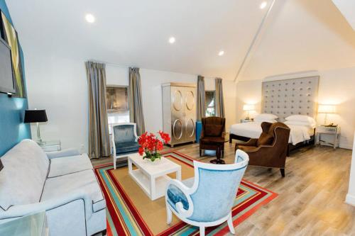 a hotel room with a bed and a living room at L.A. Sky Boutique Hotel in Los Angeles