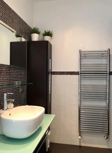 a bathroom with a white sink on a counter at onde house casa vacanze Le Grazie in Portovenere