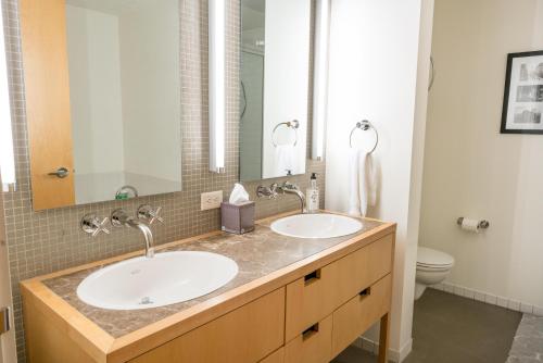 a bathroom with two sinks and a toilet at Promenade Unit 311 in Denver
