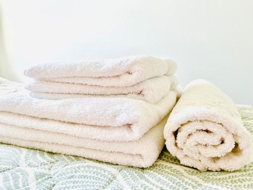 a pile of towels sitting on top of a bed at Oasis Apartments in Bijeljina