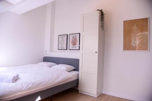 a bedroom with a bed and an open door at Apartamenty Turystyczna 25 in Kudowa-Zdrój