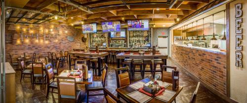 a restaurant with tables and chairs and a bar at Rosen Shingle Creek Universal Blvd in Orlando