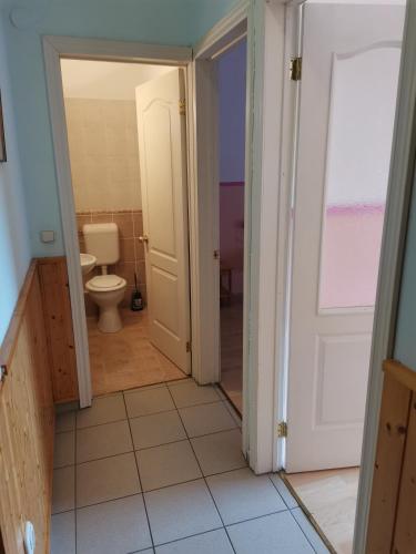 an open door to a bathroom with a toilet at Anno 2000 in Balatonlelle