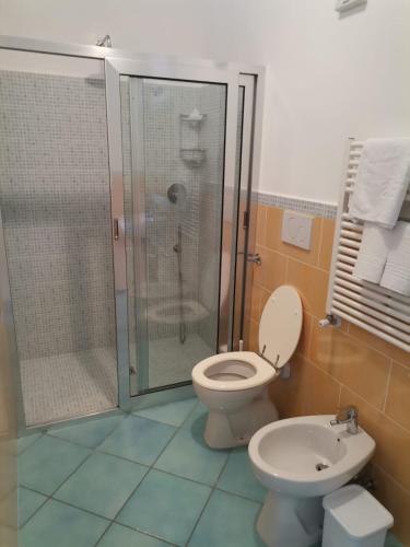 a bathroom with a shower and a toilet and a sink at Residenz e Ristorante da Mimì in Ischia