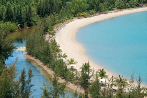 an aerial view of a beach with trees and water at L'Alya Ninh Van Bay in Ninh Van Bay