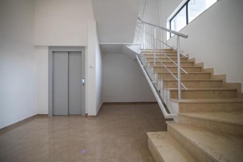 an empty room with stairs and a door at July in Trebinje