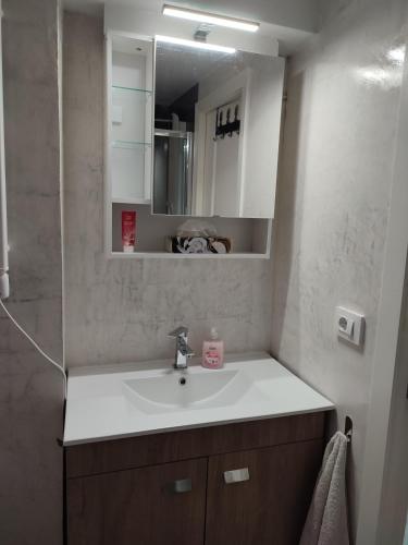 a bathroom with a sink and a mirror at Casa Máxica de Oia in Oia