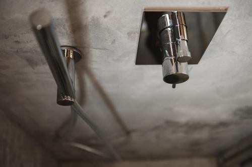 two metal pipes hanging from a wall at Casa di Melo - Organic Country Hotel in Cassibile