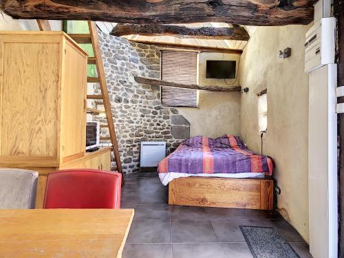 a bedroom with a bed and a table in a room at Gite et chambres de la porte du parc in Les Iffs